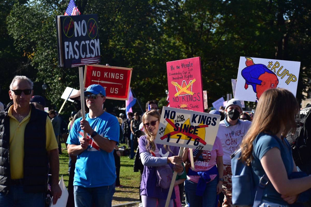 Protesters hold signs at the No Kings protest at Boston Common Oct. 18. No Kings rallies took place nationwide, and this was Boston’s second No Kings protest since the second Trump administration took office in January. 
