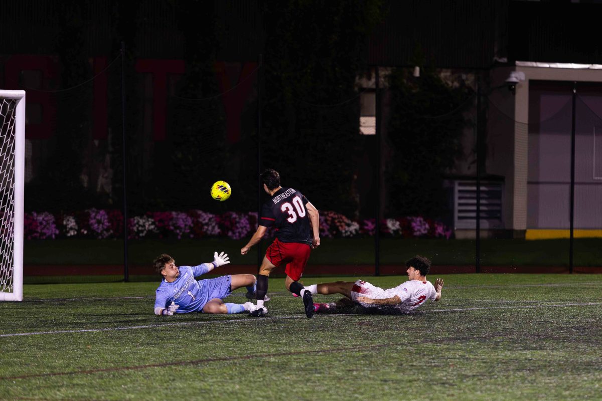 Junior forward Andrea Di Blasio (7) attempts to shoot the ball on goal, but his shot is blocked. On Tuesday night, Boston University men’s soccer lost 3-2 to Northeastern.
