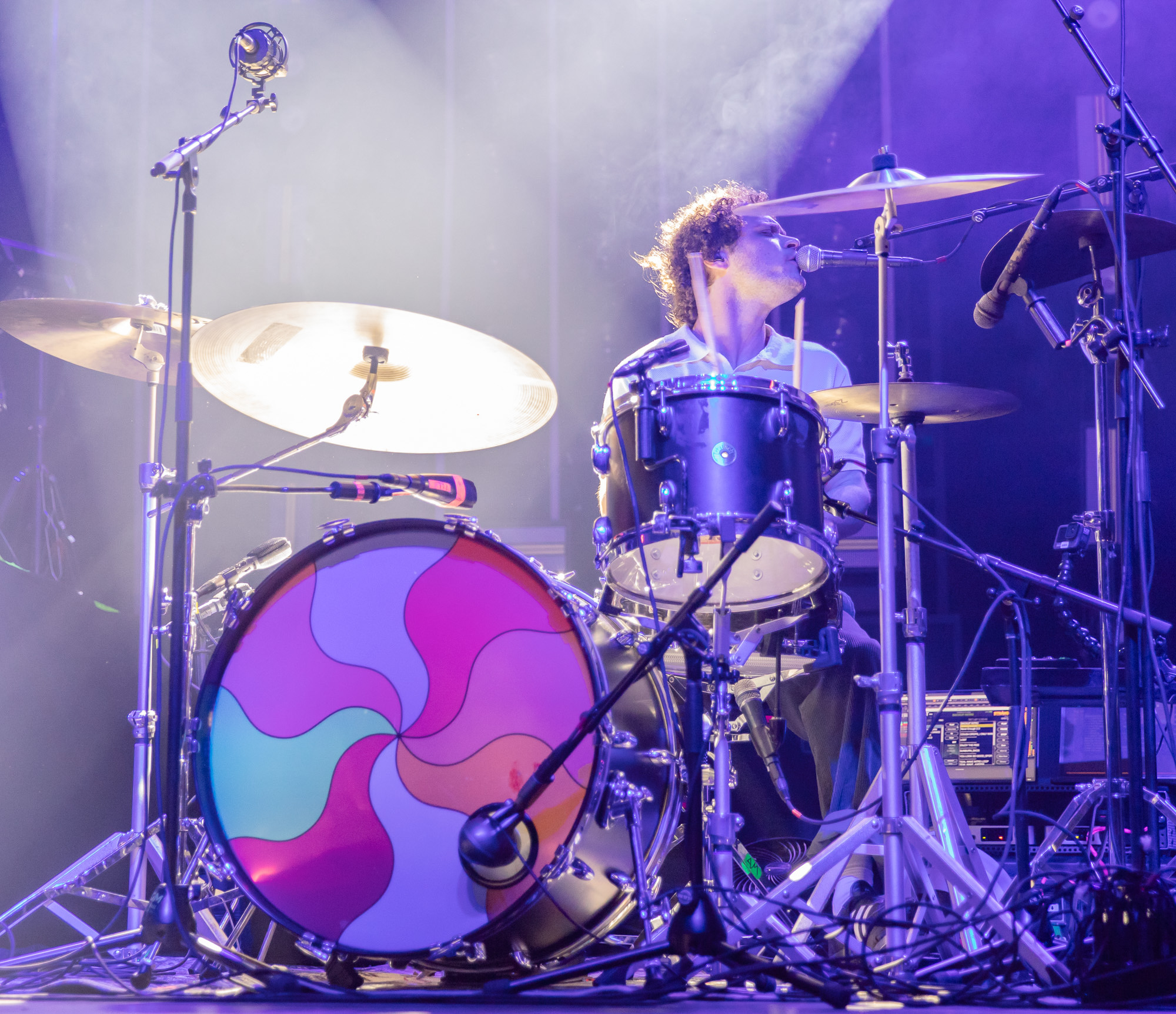 Rafael Vidal, touring drummer for almost monday sings into the microphone.