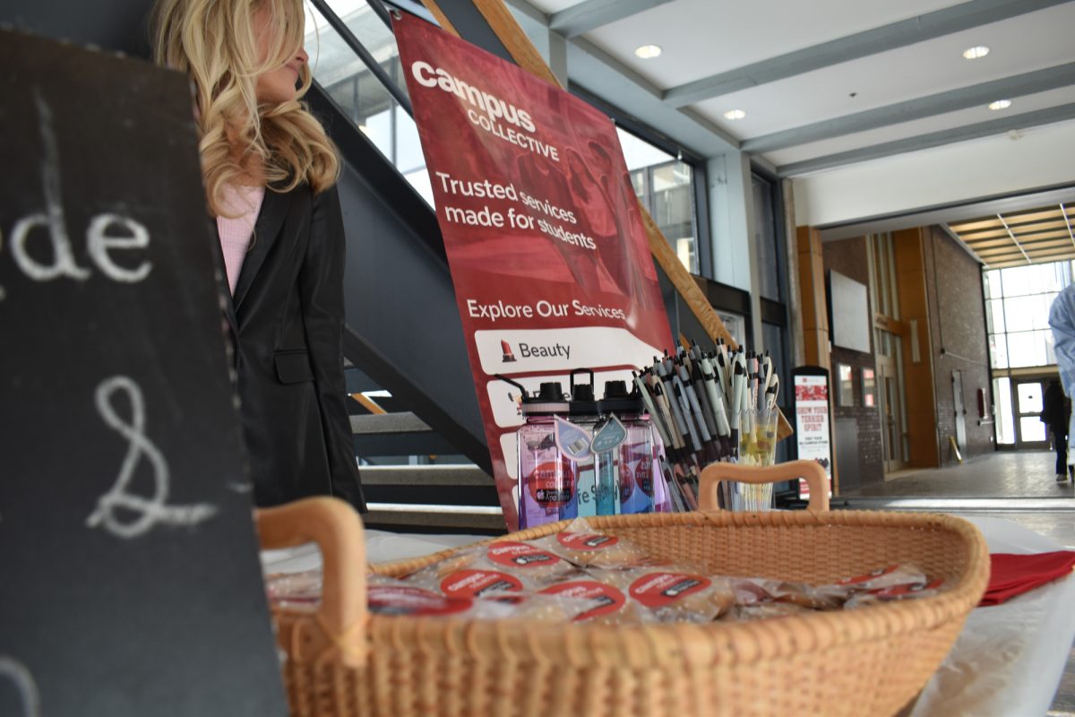 Campus Collective’s table set-up at the George Sherman Union. BU alum Alexis Ward said she founded the app to help students book and offer lifestyle services. 