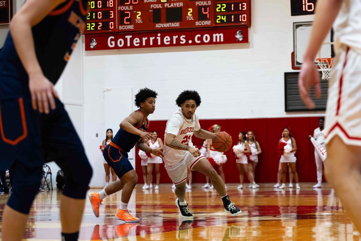 Freshman guard Donte Tisinger Jr. (21) travels with the ball during a game against Bucknell University Saturday. The Boston University men’s basketball team won 85-58 against the Colgate Raiders Monday.  