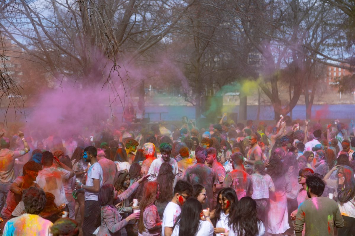 A sea of Holi participants move to music.