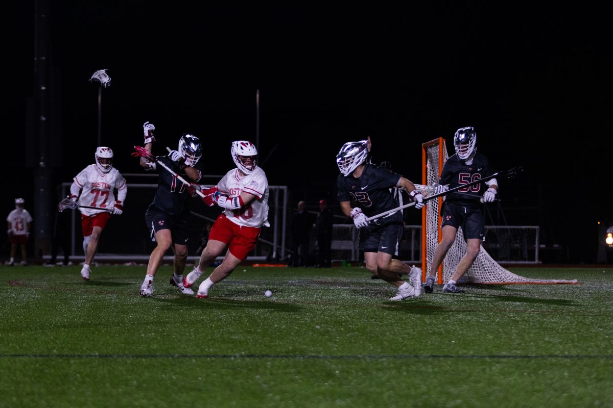 Boston University senior attack Tommy Garofalo (40) and Harvard junior defender Wyatt Wiggins (23) battle after a loose ground ball. BU’s men’s lacrosse team lost 14-11 to No. 3 Harvard in the second-branded edition of the Charles River Rivalry.
