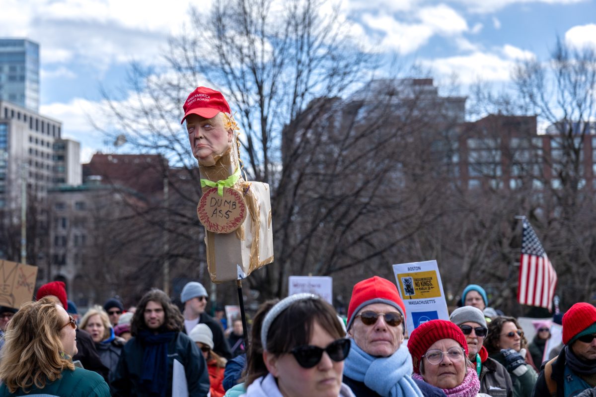 A Trump-faced piñata pokes above the crowd. 