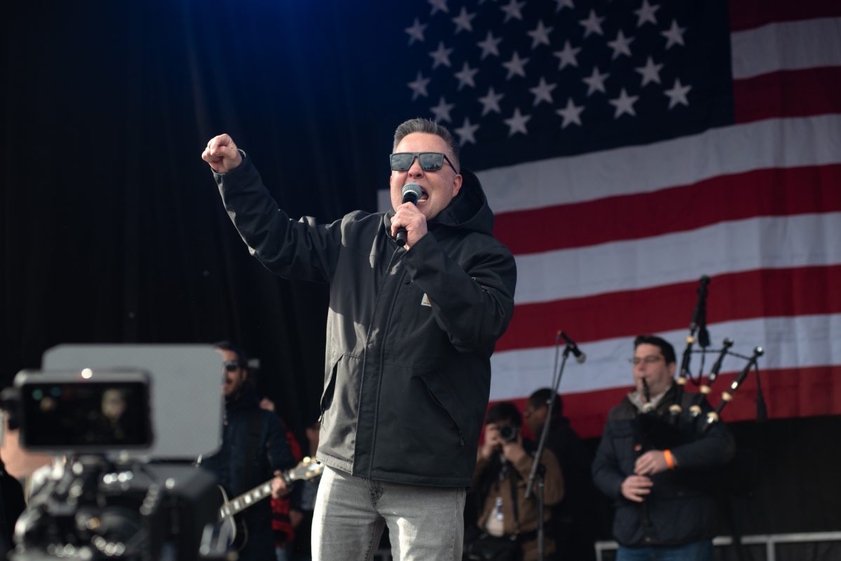 Ken Casey of Dropkick Murphys fist-pumps as he moves across the stage. The Celtic punk band performed at “No Kings” on Boston Common Saturday.