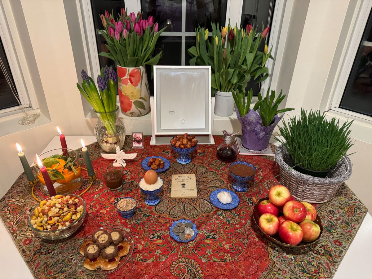 A table decorated with food and flowers at a Persian cultural celebration. After the U.S. and Israeli governments began a joint bombing campaign on Iran on Saturday, Iranian students at Boston University and around Boston expressed mixed opinions. (PHOTO COURTESY OF KAVEH, an Iranian BU graduate student who chose to use a pseudonym to protect his safety)