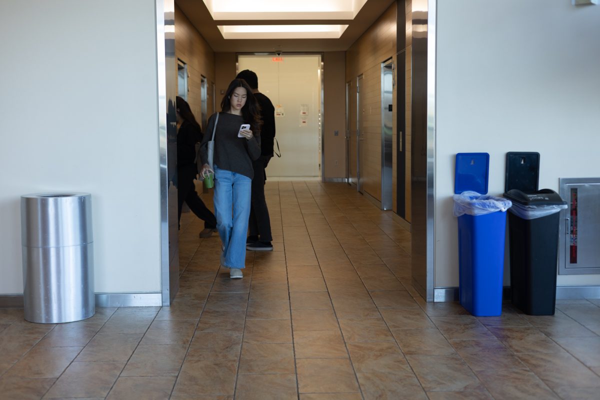 Students walk to and from Student Village II elevators.