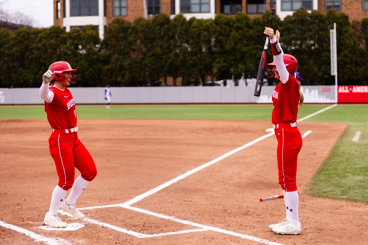 First baseman Megan Coyle (6) celebrates a home run with centerfielder Camryn Lyons (2). Coyle broke the single-game record for most runs batted in program history, enroute to leading the BU softball team to two wins over the Bucknell University Bison in a weekend doubleheader.