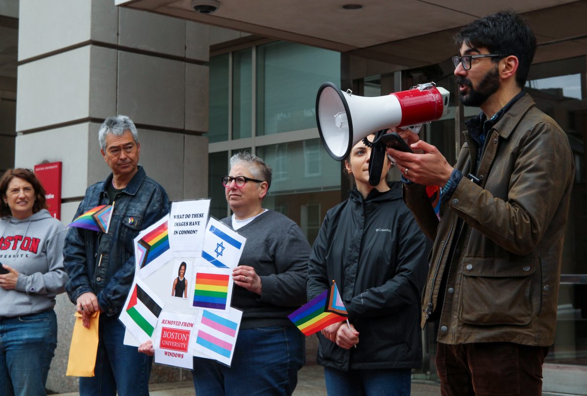 Boston University LAW clinical associate professor Angelo Petrigh delivers a message to a crowd gathered outside BU President Gilliam’s office at a rally on Thursday. Dozens gathered at 1 Silber Way to protest BU’s pride flag removal policy.