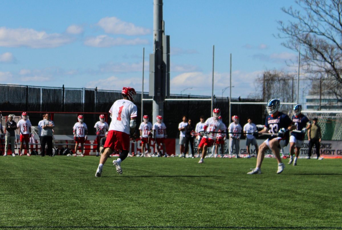 Sophomore attack Timothy Shannehan (1) squares up against Bucknell junior defenseman Caleb Lewis (33). Shannehan scored the overtime game-winning goal in BU men’s lacrosse team’s 13-12 win over the Bucknell University Bison. 