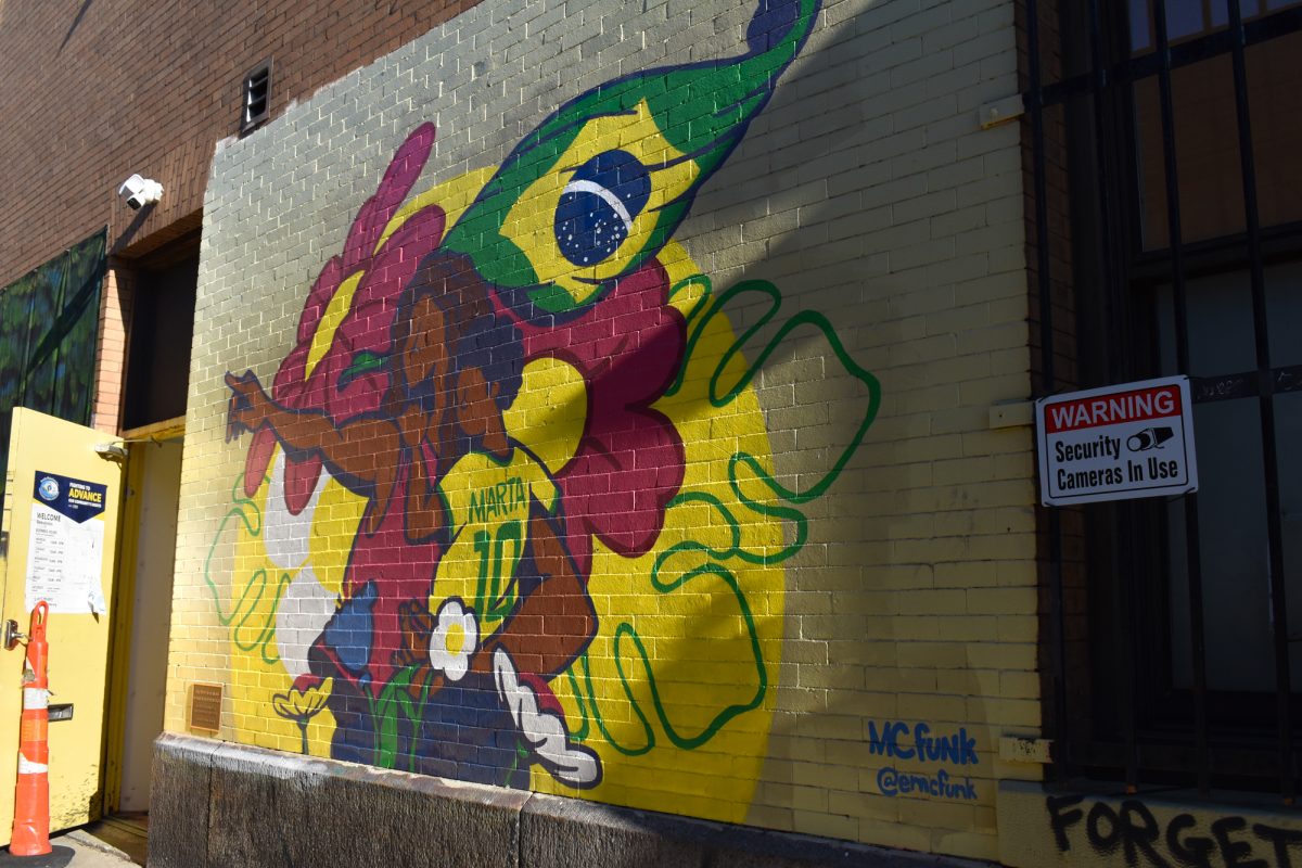 The Marta mural on one side of the Brazilian Worker Center, painted by artist Eric Funk. Funk and other artists collaborated with local businesses to combat graffiti in Allston neighborhoods as part of the Murals in Motion program.