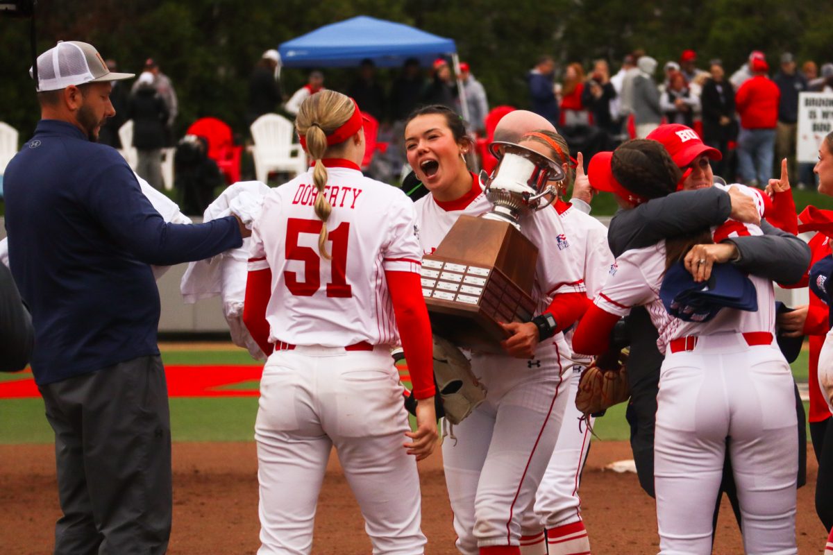 Senior pitcher Kasey Ricard celebrates the win with the trophy.