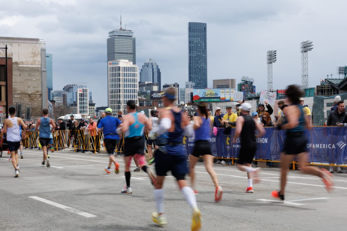 Boston Marathon racers run by crowds near Fenway Park. DEXA Scan, a Brookline-based body scan clinic, aims to help marathon runners and other athletes better understand their physical health.