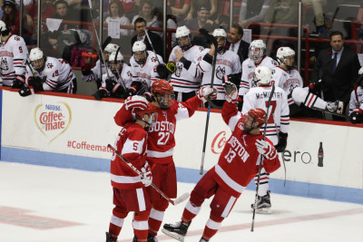 (From left) Matt Grzelcyk, Doyle Somerby and Nikolas Olsson celebrate Somerby's goal in the second period. PHOTO BY JUSTIN HAWK/DAILY FREE PRESS STAFF