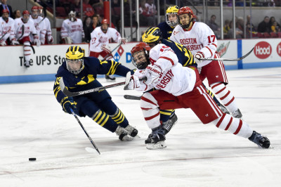 Senior Danny O'Regan fights for a loose puck with the University of Michigan defense in BU's 4-2 loss. PHOTO BY MADDIE MALHOTRA/DAILY FREE PRESS STAFF