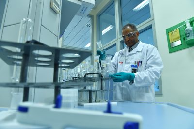 scientist examines a vial in a lab