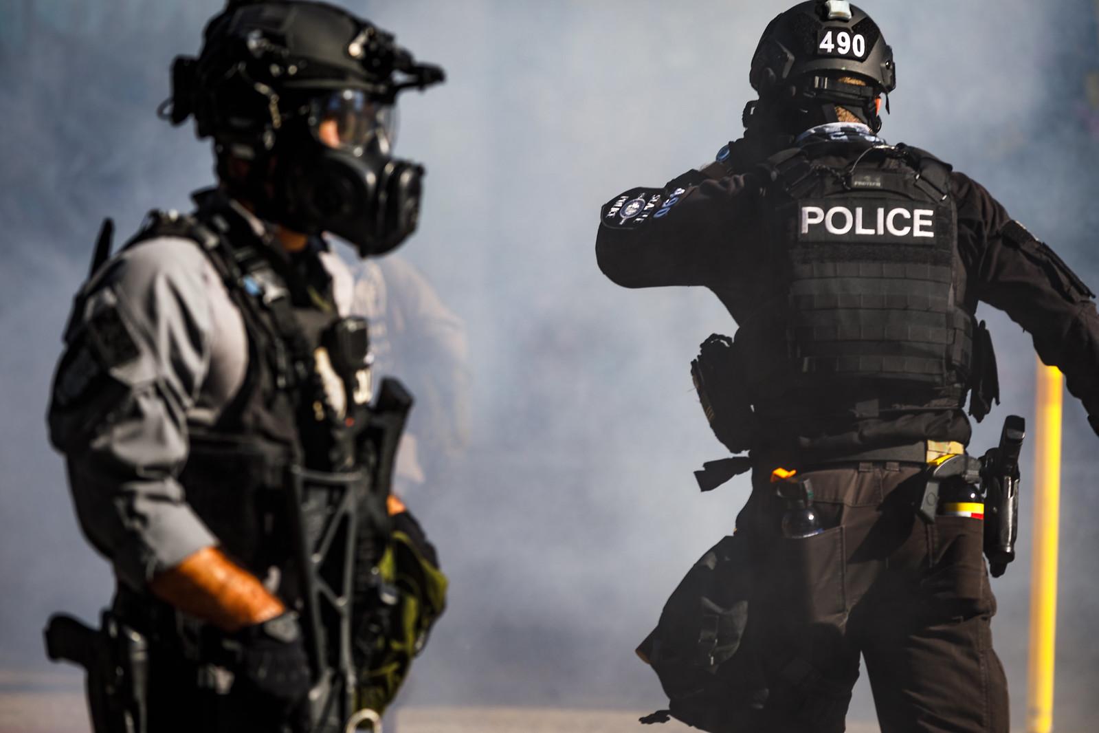 Police officers deploying a chemical agent