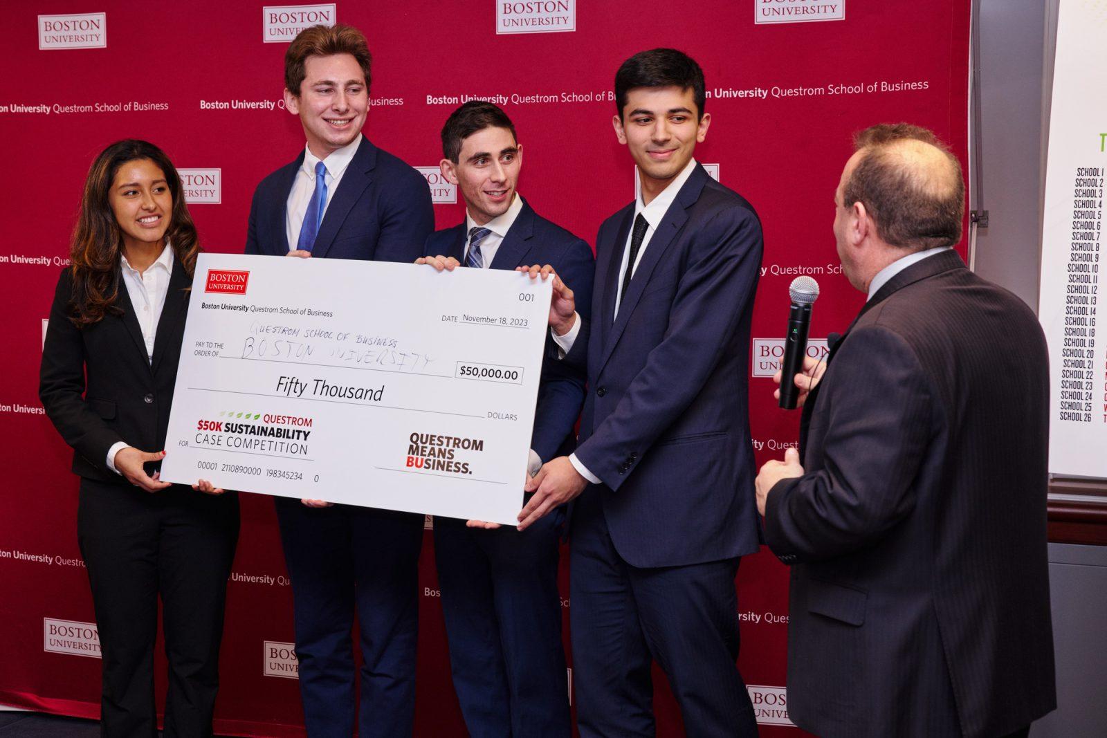 (From left) Suraj Nellore, Illiana Arroyo, Jason Wexler and Devin Hirsch display their $50 thousand prize won at the Business Sustainability Case Competition at the Questrom School of Business on Nov. 18. PHOTO COURTESY OF DAVE GREEN