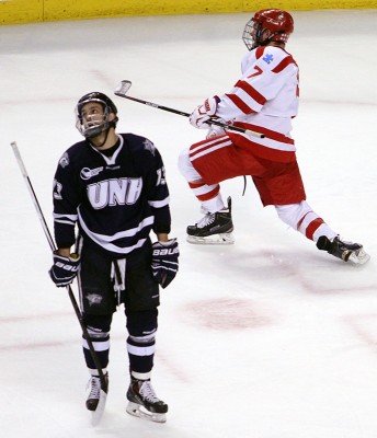 Cason Hohmann celebrates his game-tying goal in the first period as UNH forward Dan Correale looks on. PHOTO BY MAYA DEVEREAUX/DAILY FREE PRESS STAFF