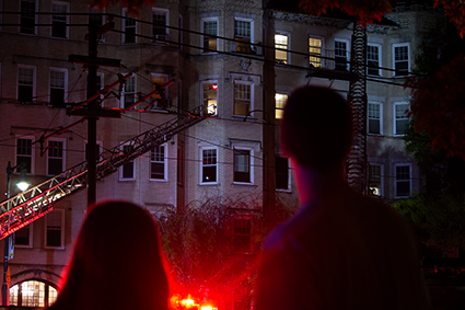 Students look on as firefighters work to put out the fire at 722 Comm. Ave.  PHOTO BY VIGUNTHAAN THARMARAJAH/ DAILY FREE PRESS STAFF