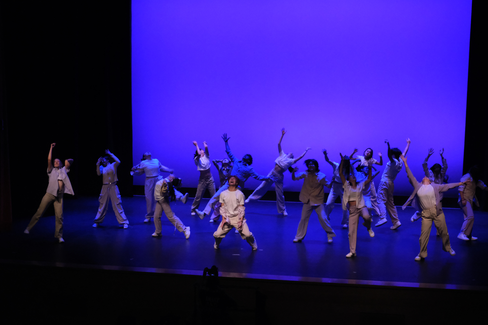 BU Unofficial Project expresses while performing on stage.