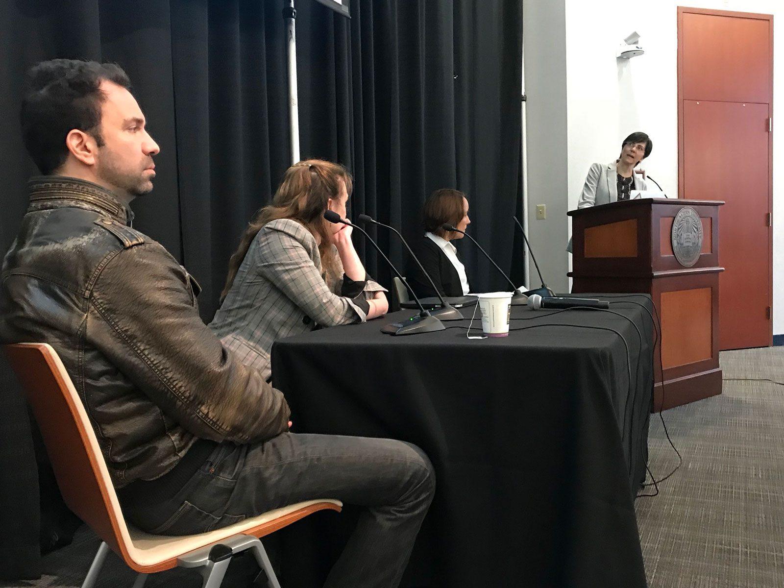From left to right: Jonathan Stray, Cesca Antonelli and Lisa Gibbs listen to professor Meg Heckman’s remarks Friday at Northeastern University. COURTESY OF MATT CARROLL.