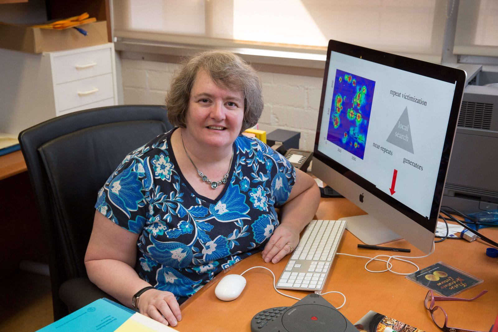 Andrea Bertozzi, a mathematics and engineering professor at UCLA, pictured with her crime modeling diagram. Bertozzi shared her use of data analytics in her seminar “Mathematics of Crime” on Thursday at the Boston University Math and Computer Science building. COURTESY OF ANDREA BERTOZZI