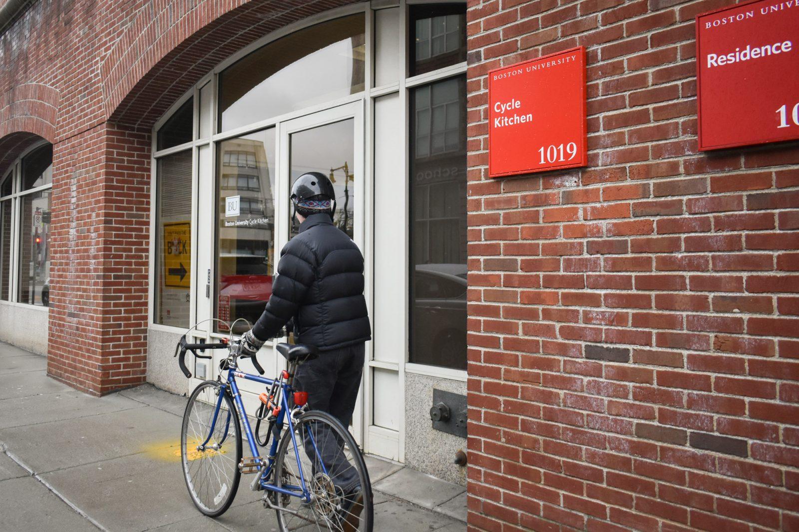 Sophomore Eli Gately walks his bike into the BU Cycle Kitchen (BUCK) to fix a flat tire. The BUCK opened last semester with the intention of providing students and employees a space to learn how to repair their bikes themselves. LILY HANSEN/DFP PHOTOGRAPHER
