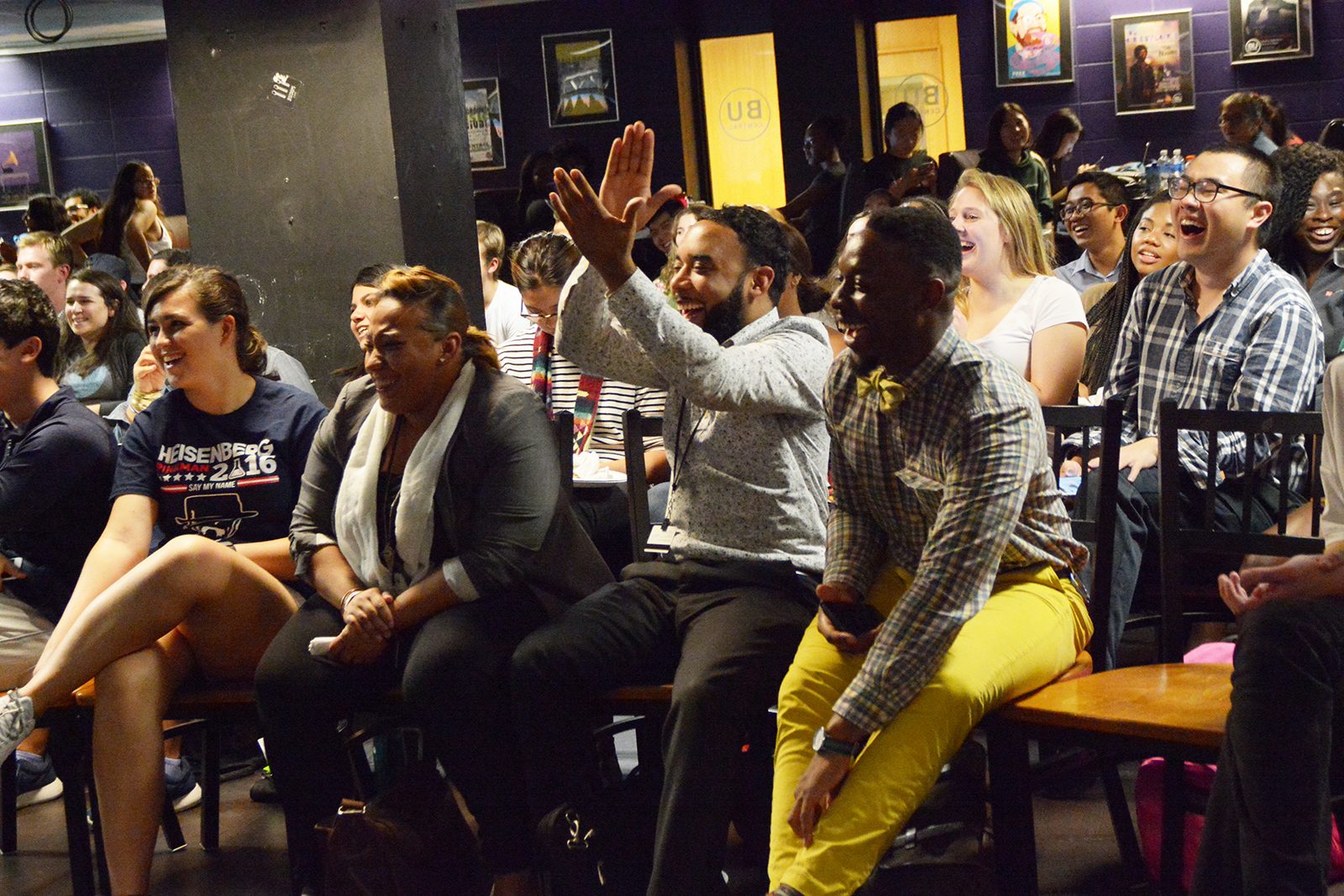 Isaque Rezende (MET ‘18) and Alua Aumade cheer for a remark made during the third presidential debate at BU Central's viewing party. PHOTO BY JESS RICHARDSON/ DAILY FREE PRESS STAFF