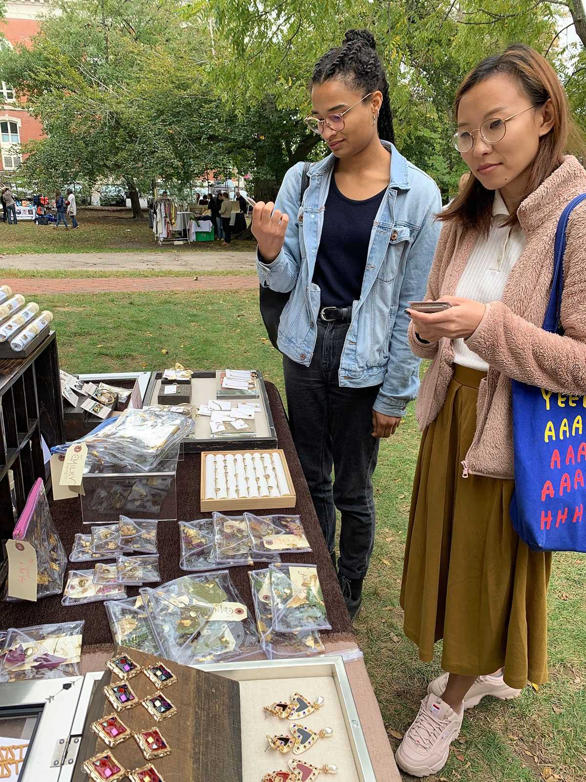 Attendees browse jewelry on display at the Boston Women’s Market in Jamaica Plain on Sunday, an event that highlights female entrepreneurs. COURTESY OF BOSTON WOMEN’S MARKET