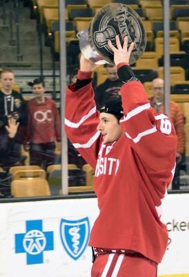 Sophomore forward Robbie Baillargeron hoists the Beanpot trophy after the No.2/3 Boston University men's hockey team defeated Northeastern 4-3 in overtime. PHOTO BY JUSTIN HAWK / DAILY FREE PRESS STAFF