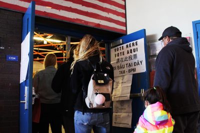 People stand in line to vote at the Jackson/Mann K-8 School in Allston on Election Day. PHOTO BY BRIGID KING/ DAILY FREE PRESS STAFF
