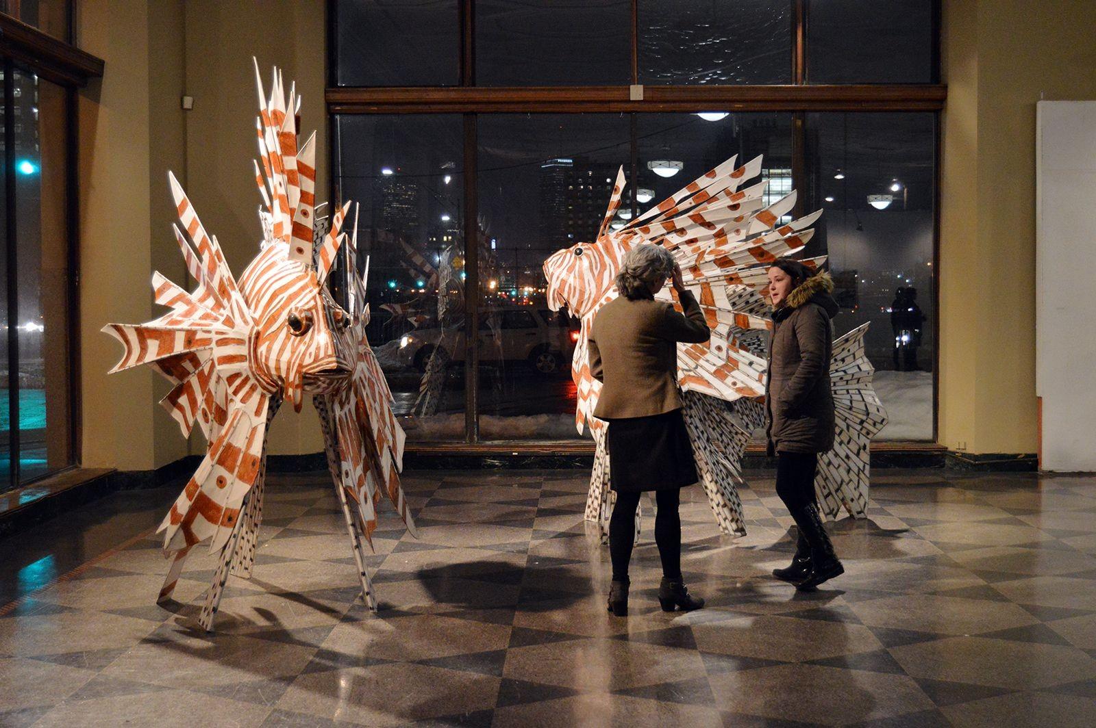Attendees view a sculpture by College of Fine Arts lecturer Kitty Wales at the Faculty Exhibition at 808 Gallery Friday night. PHOTO BY ERIN BILLINGS/DAILY FREE PRESS STAFF