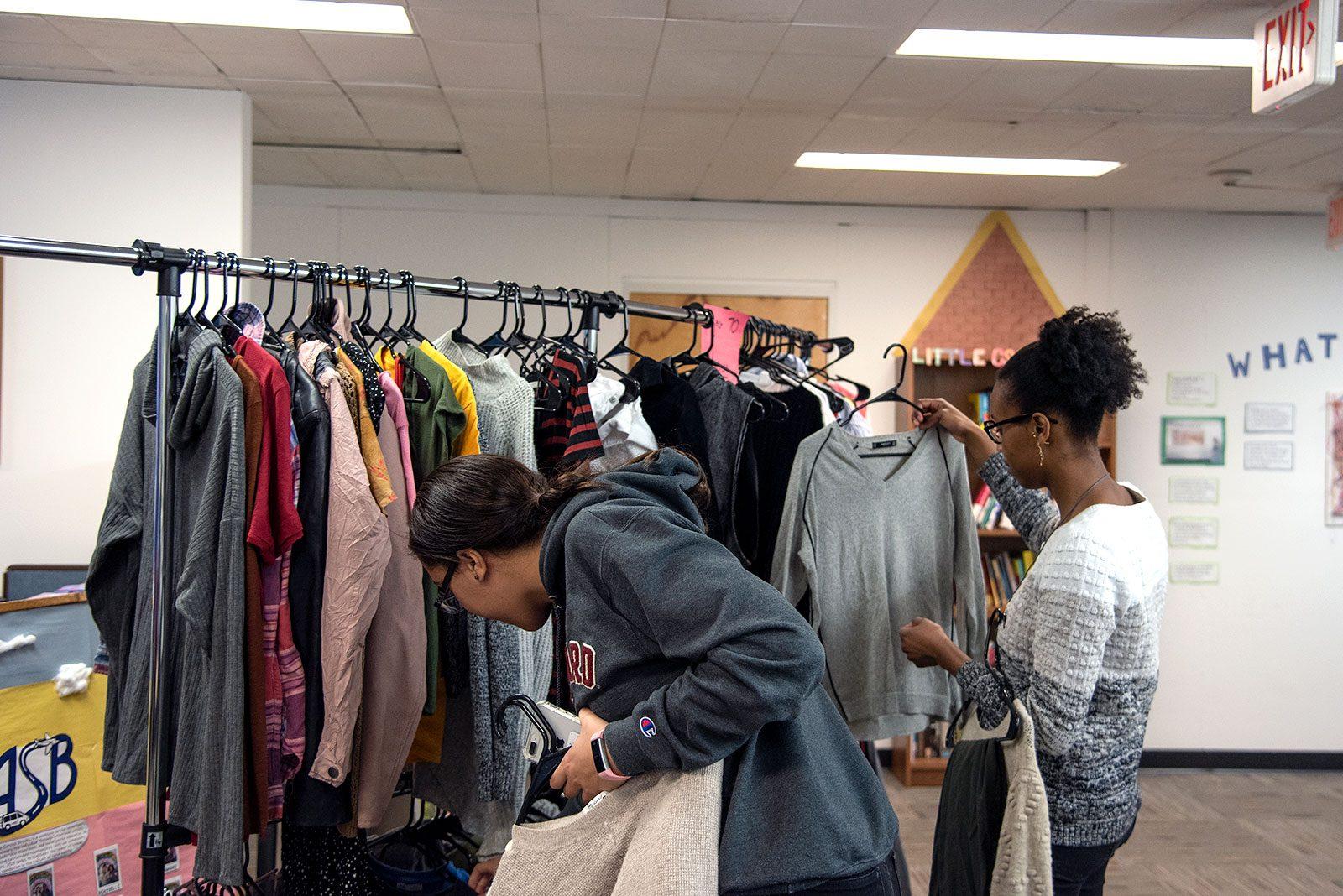 Students browse donated clothes at the Community Service Center on the fourth floor of the George Sherman Union during a weekend-long clothing swap hosted by project 70. DANIEL MU/ DAILY FREE PRESS STAFF