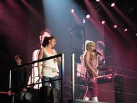 hannah montana singing on stage at a concert