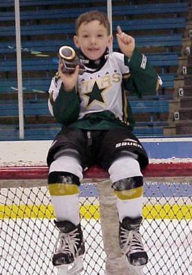 A young Cason Hohmann celebrates an ice hockey victory. PHOTO COURTESY OF CHRIS HOHMANN