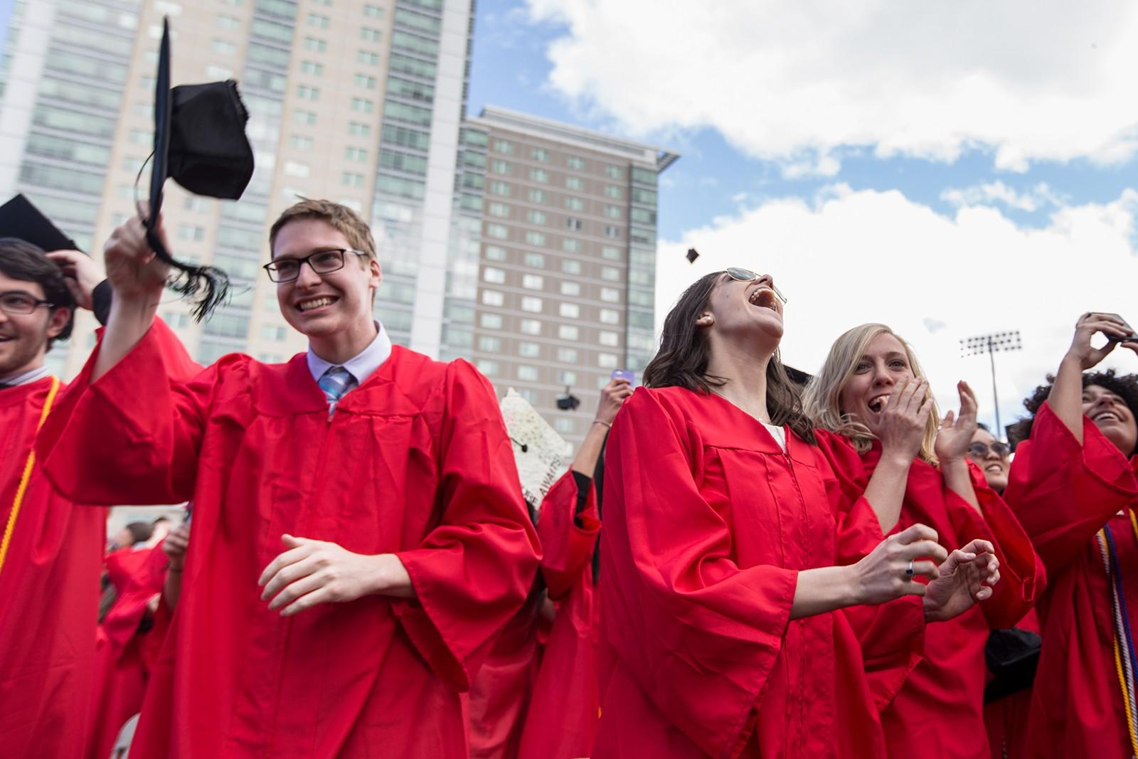 Graduates throw their caps at the conclusion of Boston University's All-University Commencement Ceremony  Sunday afternoon on Nickerson Field. PHOTO BY ALEXANDRA WIMLEY/ DAILY FREE PRESS STAFF 
