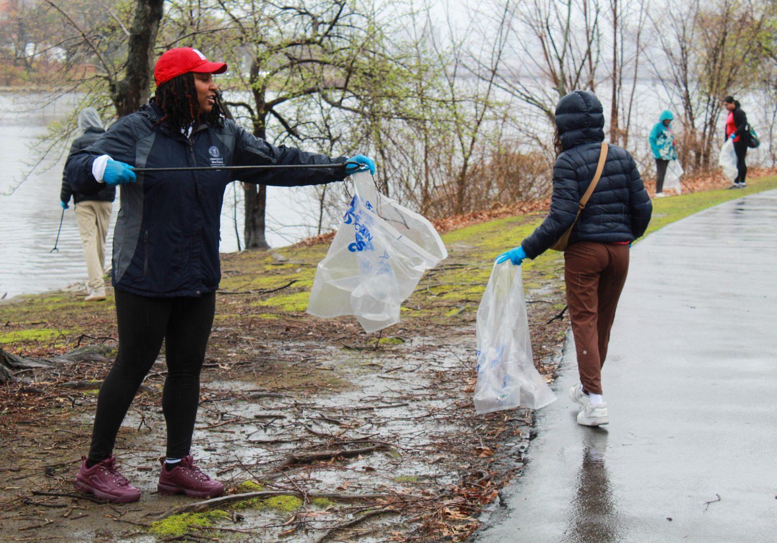 Volunteers pick up trash along the Charles River Esplanade on Saturday. BU Sustainability organized the 25th annual Earth Day Cleanup as part of its Earth Day 365 initiative. SARAH CRUZ/DFP PHOTOGRAPHER