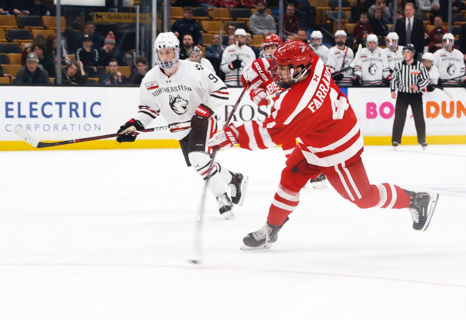 Sophomore Terrier defenseman Hugo Blixt evades an oncoming Minuteman in the ice hockey rink during a match at the University of Massachusetts last winter