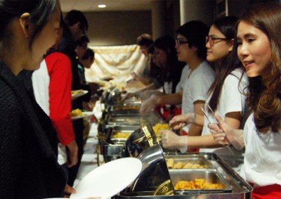 Students are served food at the Thai Festival in the George Sherman Union Thursday night. PHOTO BY BECCA DEGREGORIO/DAILY FREE PRESS STAFF 