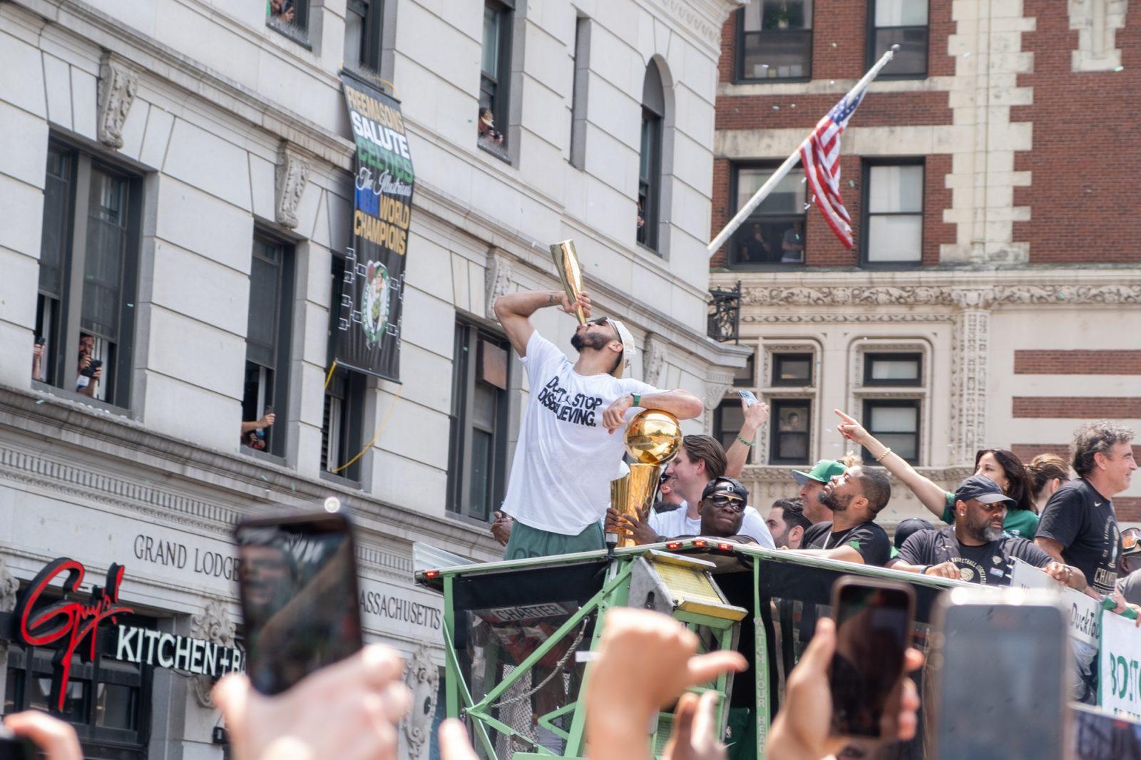 Boston Celtics forward Jayson Tatum drinks from a gold bottle during the Celtics’ championship parade on Friday. The Celtics won their 18th NBA Championship title in Game 5 against the Dallas Mavericks. PHOTO BY LINDSAY SHACHNOW