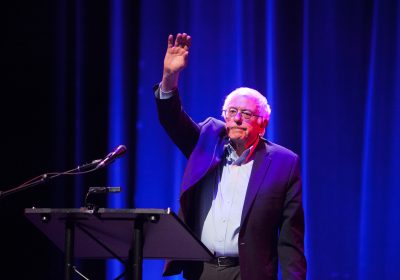 Sen. Bernie Sanders waves goodbye to the audience after his speech at the Berklee Performance Center. PHOTO BY MIKE DESOCIO/ DAILY FREE PRESS STAFF