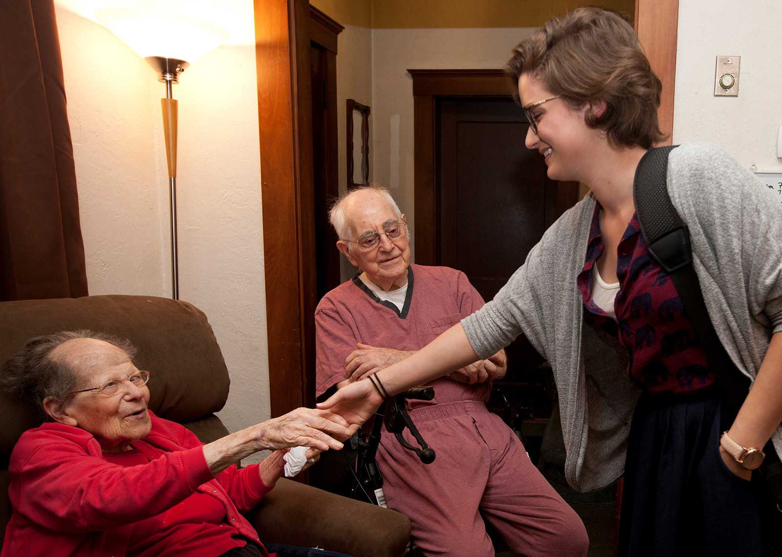 A Springwell. Inc. caregiver shakes hands with a patient. The home care service Mass Home Care, of which Springwell, Inc. is a member, has continued to provide services to their patients amidst the coronavirus outbreak, visiting the most vulnerable patients several times a week. COURTESY AMANDA SWINHART