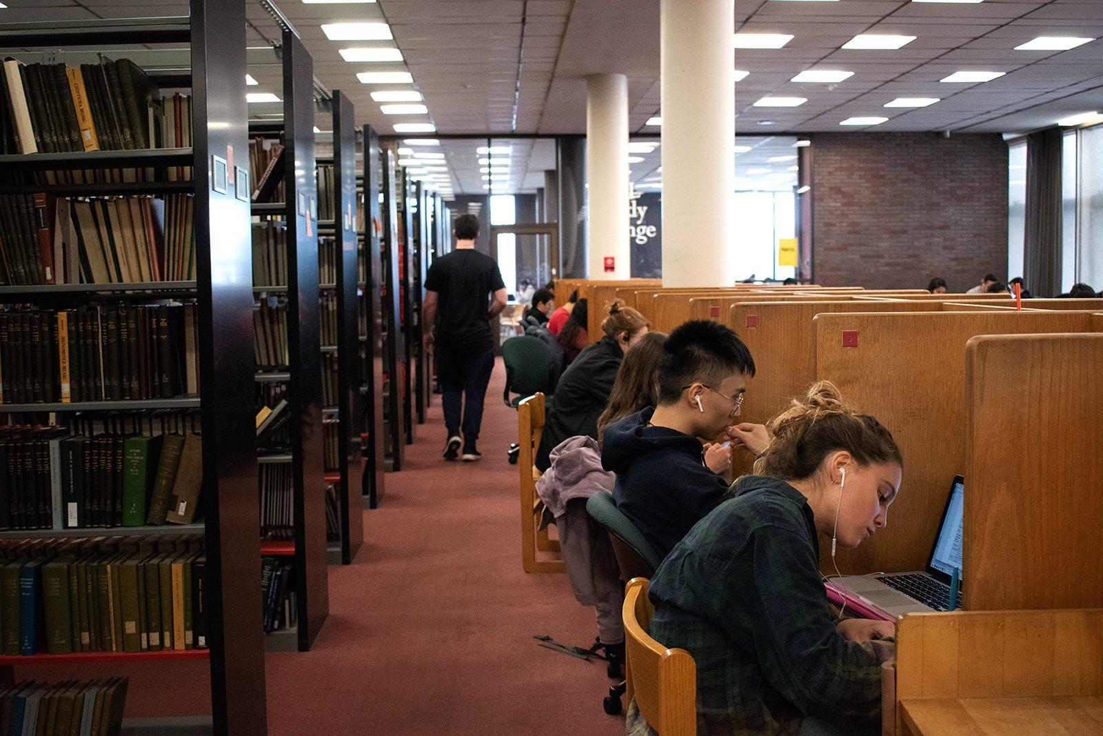 Students studying on the third floor of Mugar Memorial Library. The library will extend its hours for the finals period next week. ALI AUDET/ DFP STAFF 