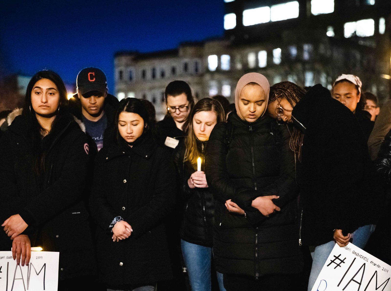 People gather together at Marsh Plaza on Tuesday night for a vigil to honor the victims of the terror attacks in New Zealand. JACOB CHANG-RASCLE/ DFP STAFF