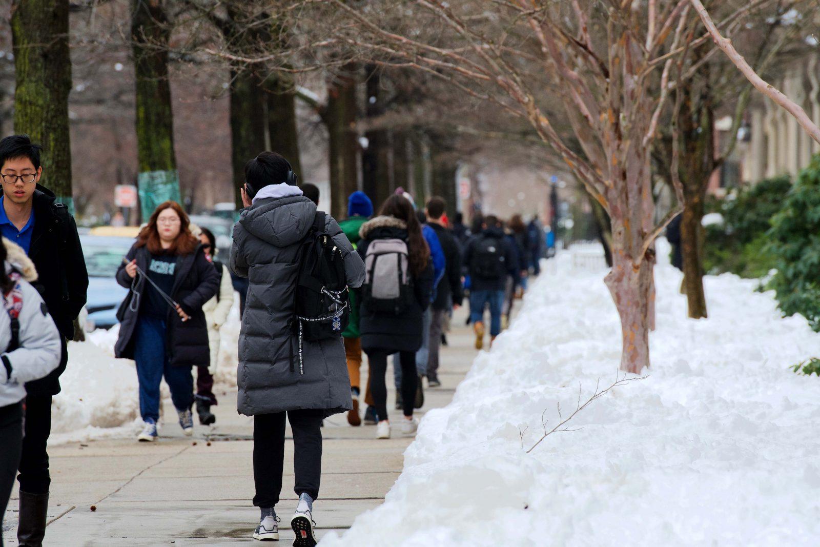 Students walk to class Monday after a 9.8 inch snowfall. Boston University administrators did not delay or cancel classes. RYAN GREGORY/ DAILY FREE PRESS STAFF 