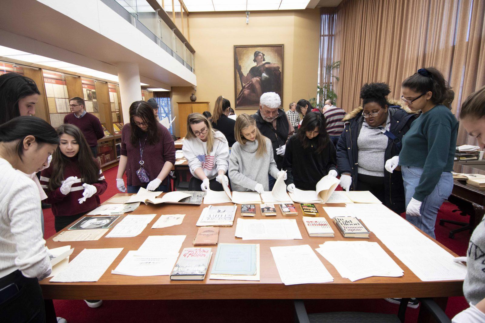 Ryan Hendrickson, HGARC assistant director for manuscripts, and Dick Lehr, a College of Communication journalism professor, lead students as they examine documents on high profile tales of crime and murder that were pulled from archives. RYAN GREGORY/ DFP STAFF