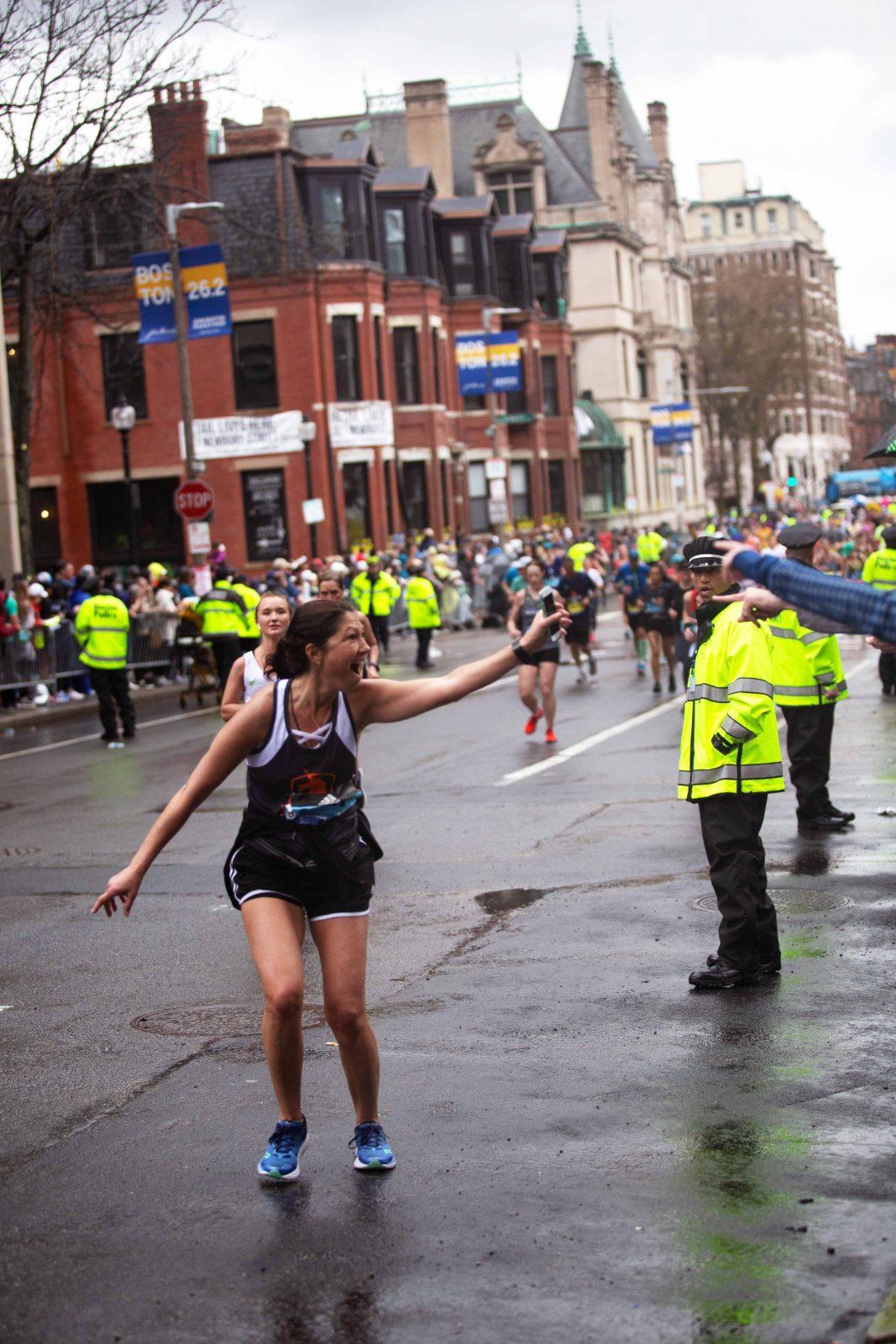 Boston Marathon runner reacts at spectators while racing. SOPHIE PARK/ DFP STAFF 