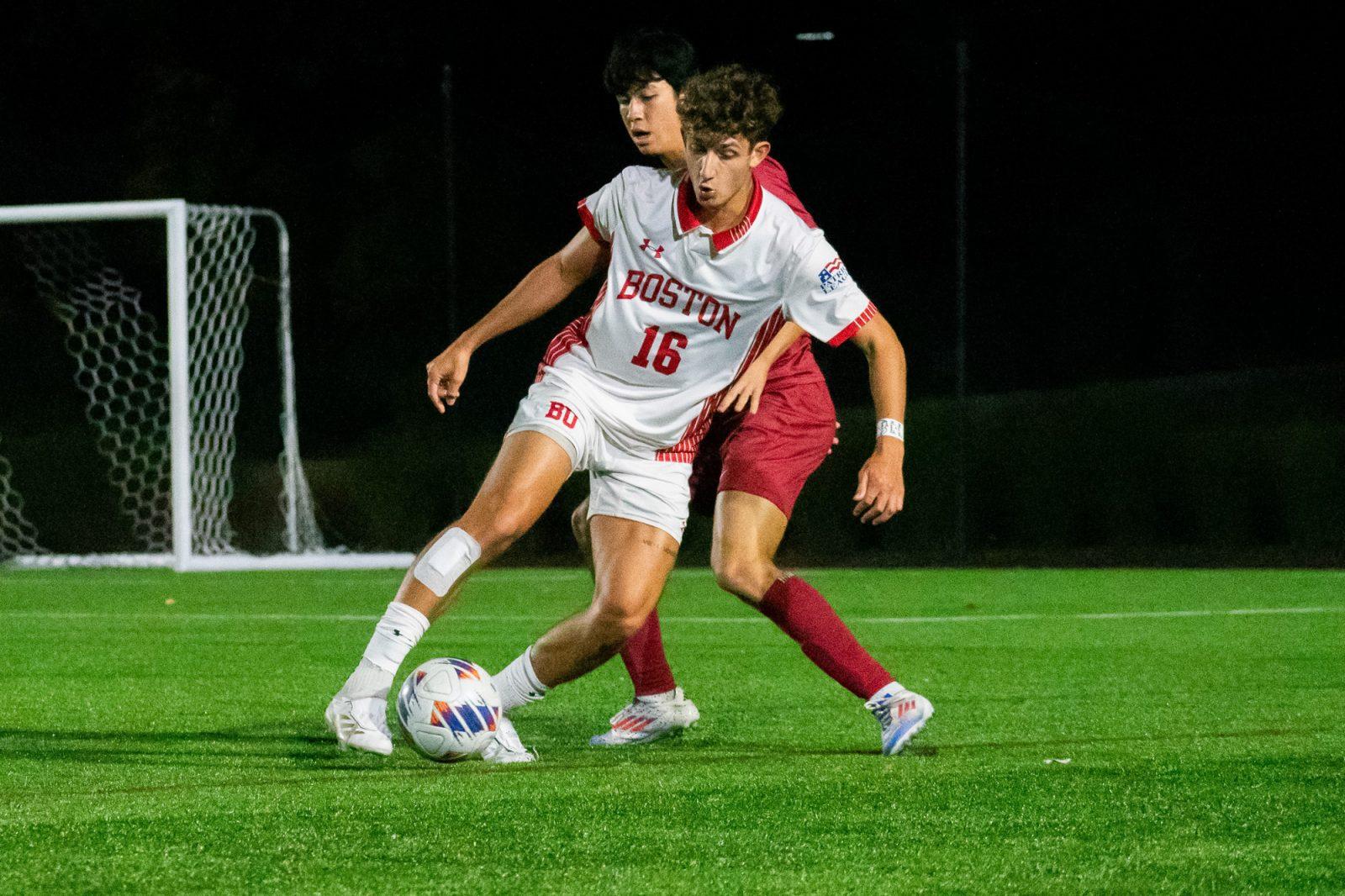 Junior defenseman Giuseppe Bagnato (16) dribbles the ball away from a Harvard player during the men’s soccer game on Tuesday. This was the eighth tie game for men’s soccer this season. KELLY BRODER/DFP PHOTOGRAPHER