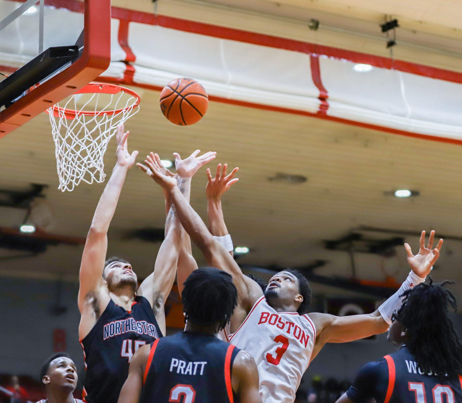 Senior forward Malcolm Chimezie reaches to grab the ball in a game against Northeastern University on Nov. 4. The Terriers won 78-50 against Dartmouth College on Saturday to earn their first victory of the season. KATE KOTLYAR/DFP PHOTOGRAPHER